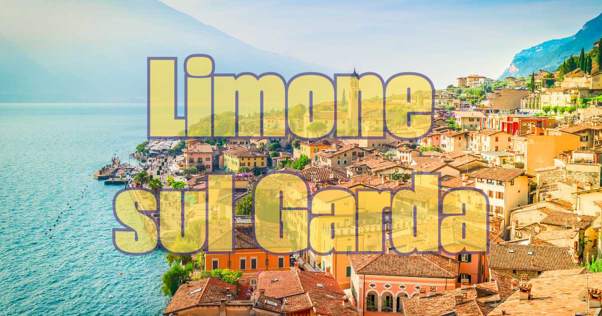 Paesaggio del Lago di Garda con un pittoresco paese affacciato sulle acque blu, circondato da colline verdi.