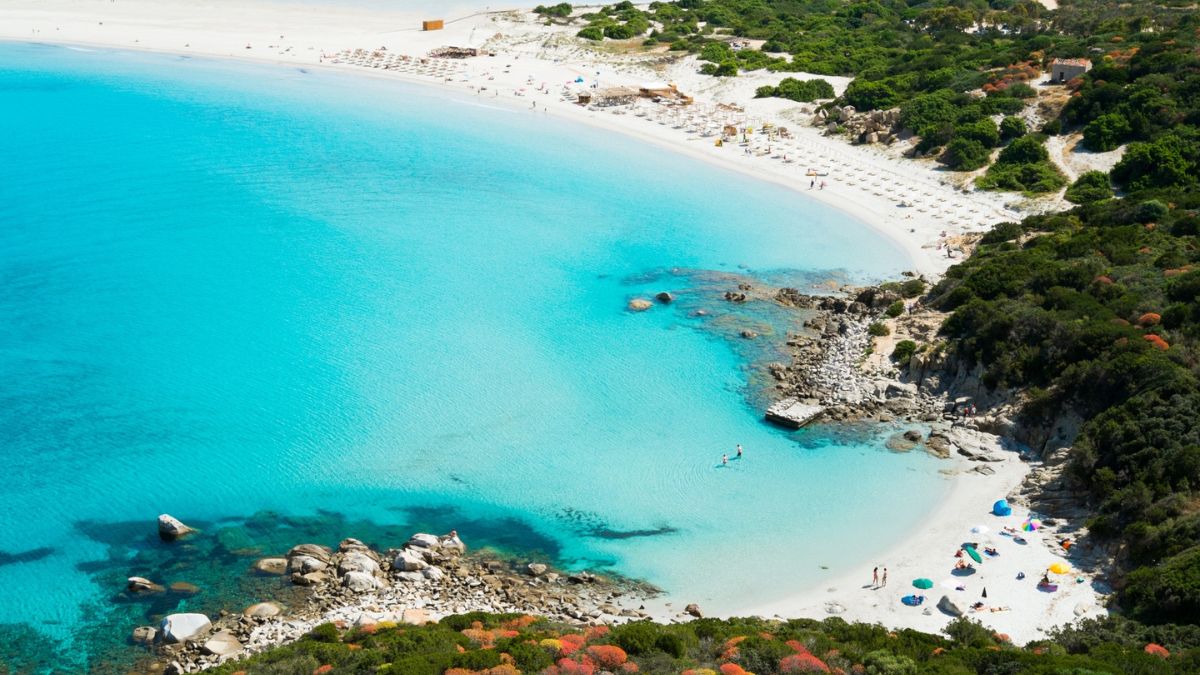 Spiaggia della Sardegna, vista panoramica, accessibile solo a piedi, con acque cristalline e sabbia bianca.